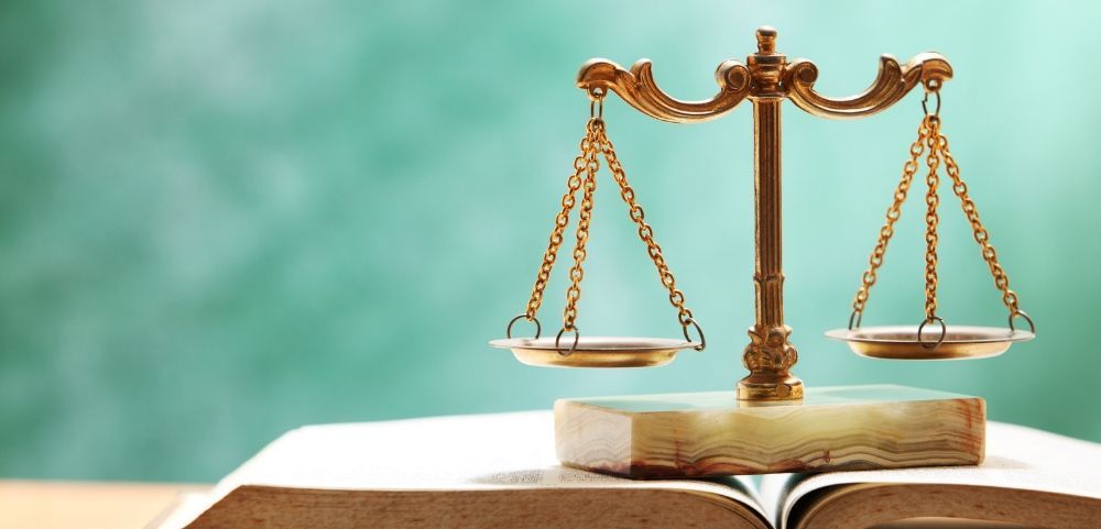 Criminal Justice- gold scales on an open book